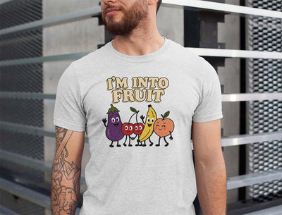 Person wearing a gray t-shirt with cartoon fruits and 'I'm into fruit' text.