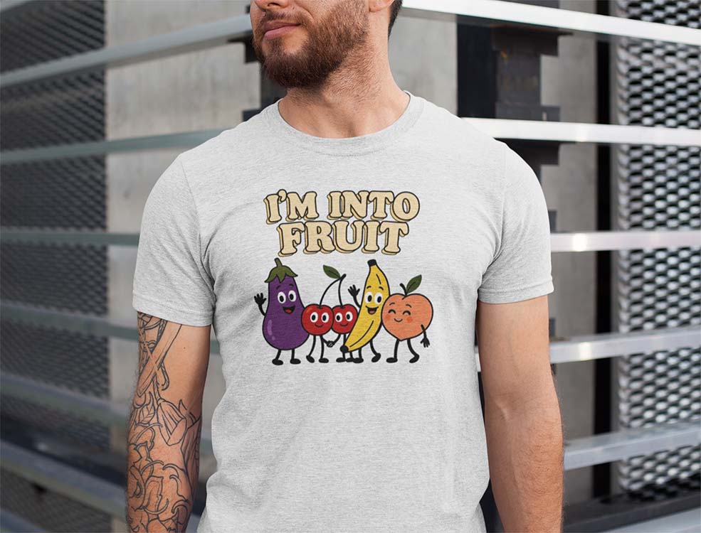Person wearing a gray t-shirt with cartoon fruits and 'I'm into fruit' text.