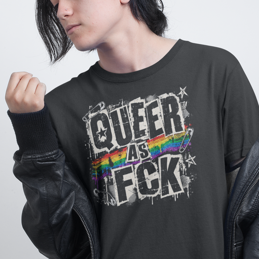 A model wearing a black graphic t-shirt with 'QUEER AS F*CK' and a rainbow design, styled with a black leather jacket against a light gray background.